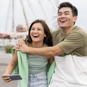 smiley-couple-embraced-outdoors